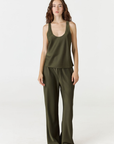Experience ultimate comfort and sophistication with the Gia Silk Pants in olive by AOCO. These luxury trousers offer a flattering fit and an elegant, flawless drape.