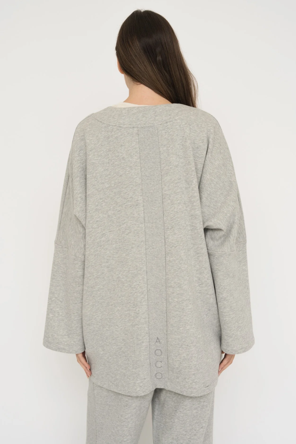 Wrap yourself in comfort with the French Terry Robe Jacket from AOCO. This versatile layer blends robe-like coziness with an everyday stylish jacket design.