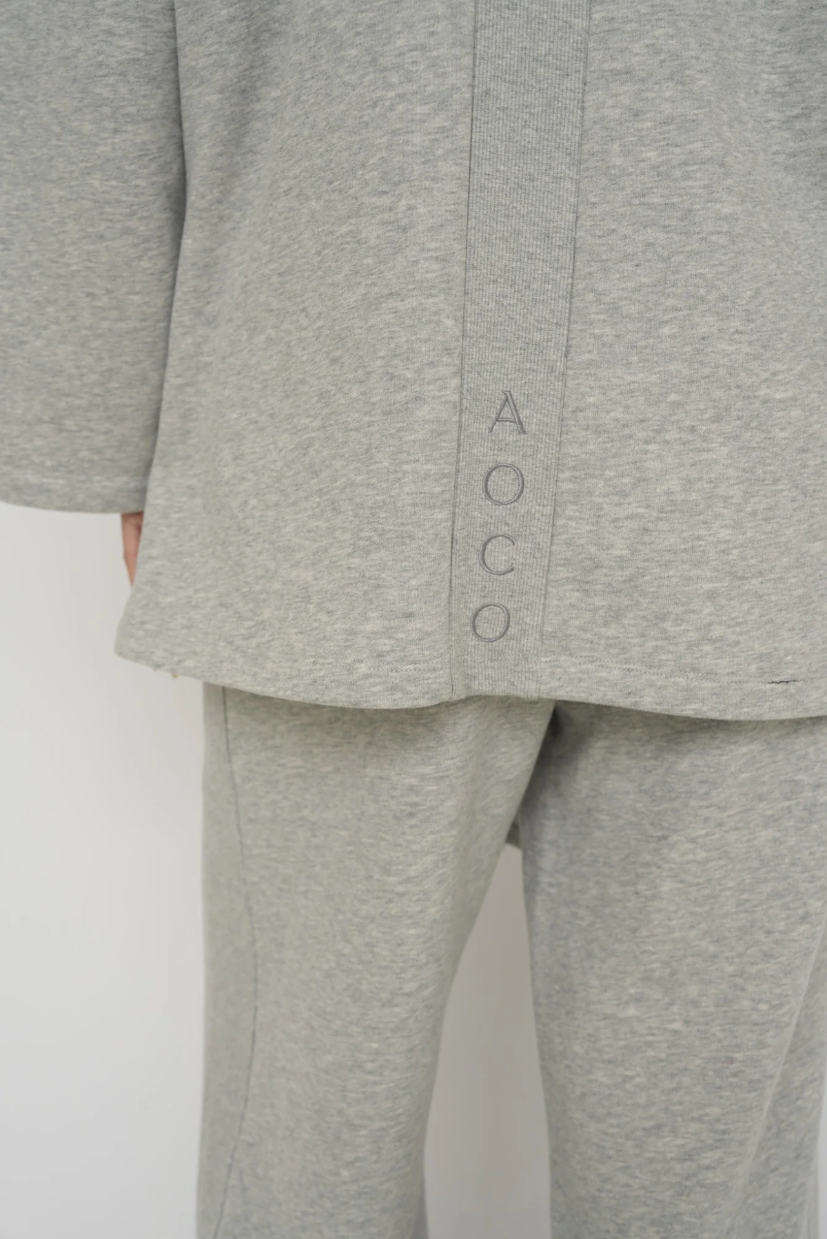 Wrap yourself in comfort with the French Terry Robe Jacket from AOCO. This versatile layer blends robe-like coziness with an everyday stylish jacket design.