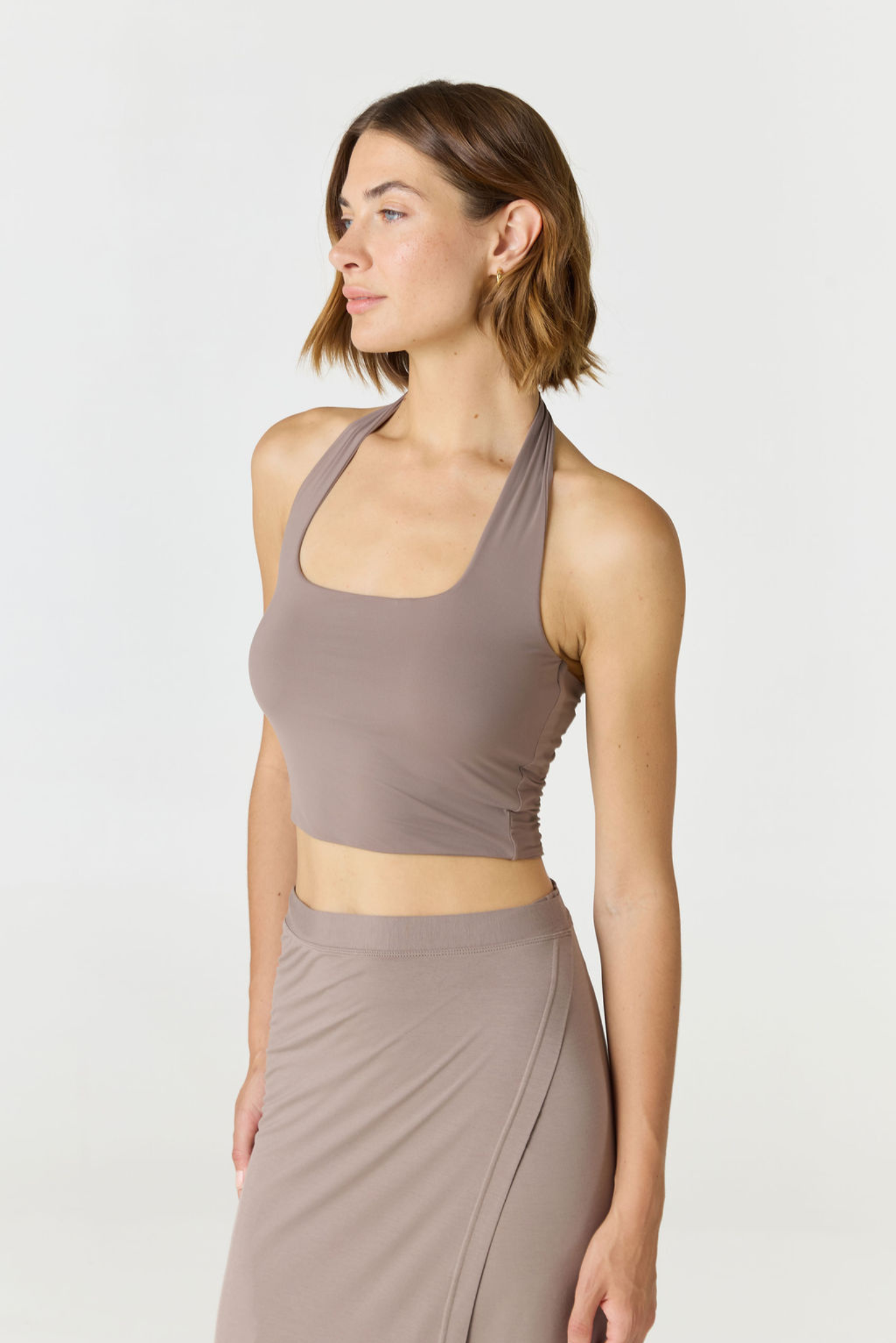 Refresh your summer wardrobe with the Mia Cropped Halter from AOCO. Featuring a chic halter neckline and a flattering cropped fit, it's a warm weather must.