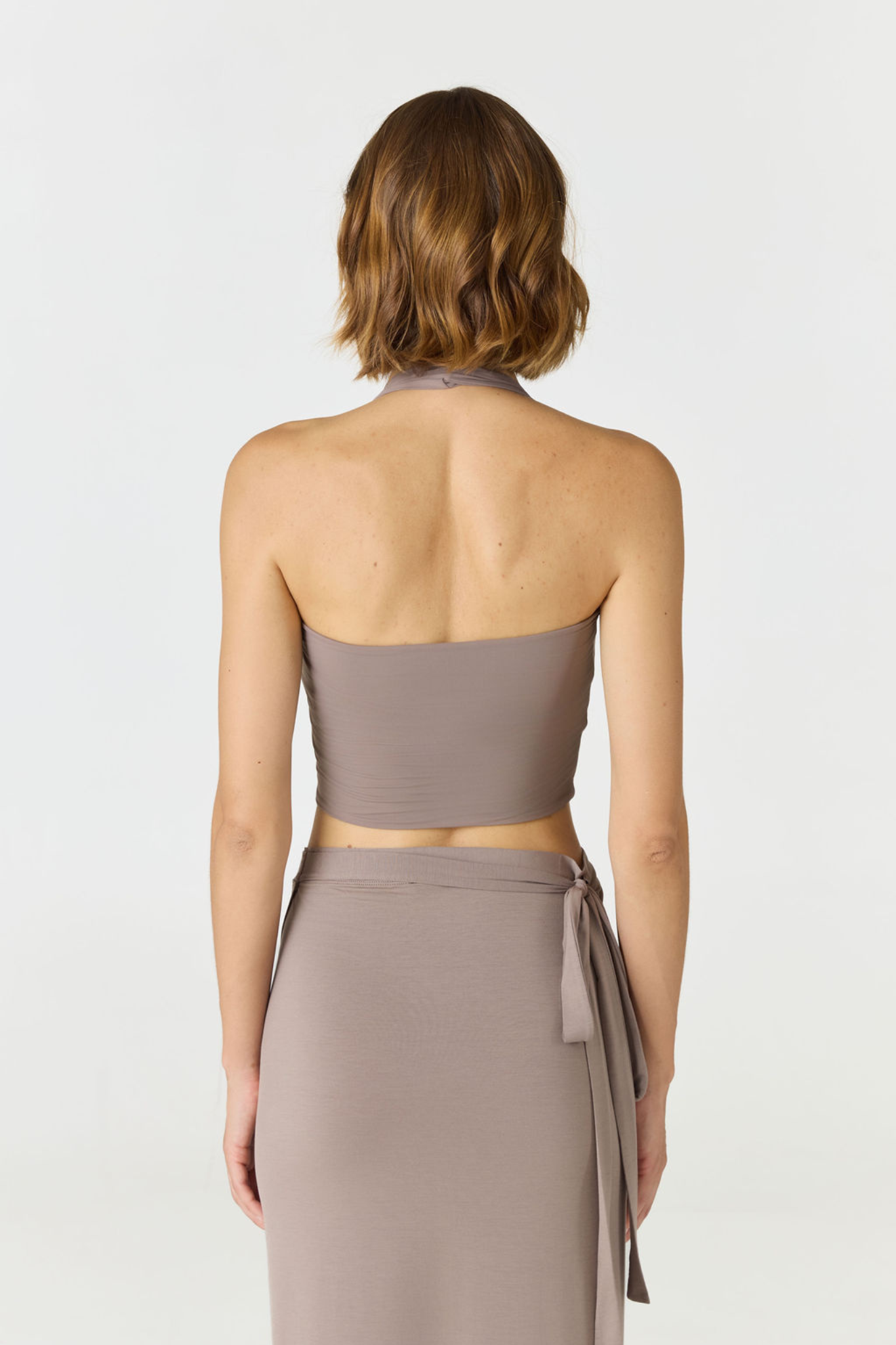 Refresh your summer wardrobe with the Mia Cropped Halter from AOCO. Featuring a chic halter neckline and a flattering cropped fit, it's a warm weather must.